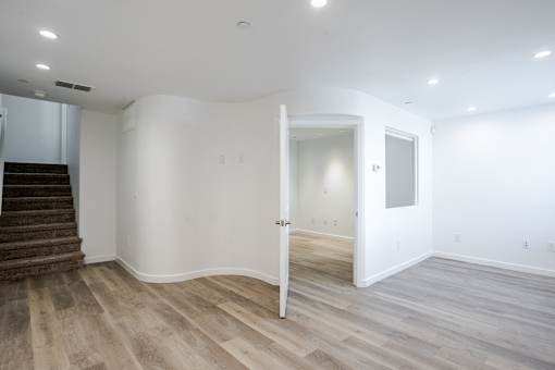 A room with a staircase and a door.