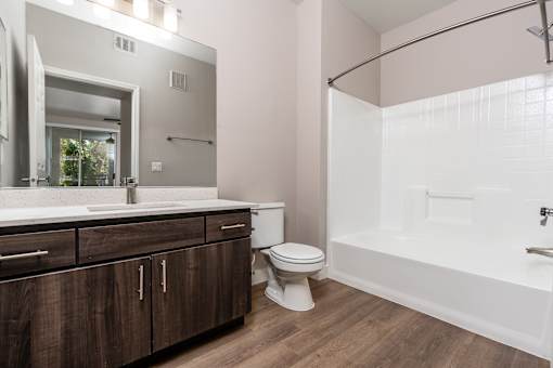 Apartments in Spring Valley for Rent - Alicante - Bathroom with Bath Tub, Shower, Wood-Style Flooring, and Large Mirror