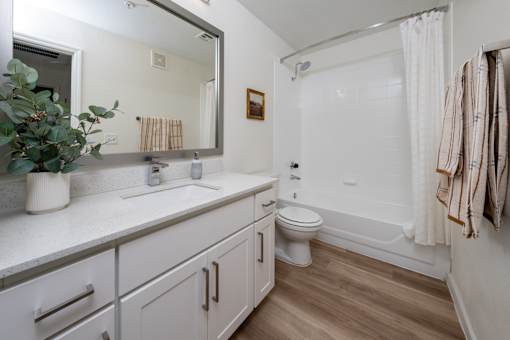 A bathroom with a toilet, sink, and bathtub.