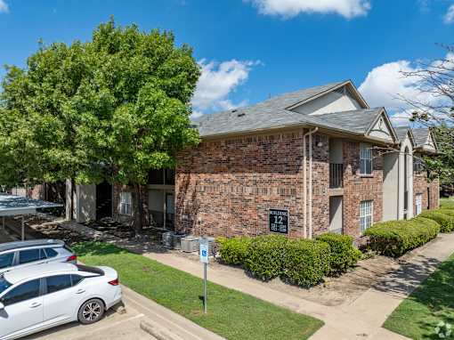 A brick building with a sign that says 123 on it.