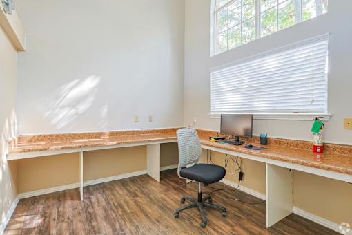 A room with a desk and a computer monitor.