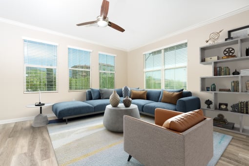 a living room with four windows and a ceiling fan