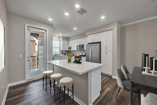 A modern kitchen with white cabinets and a central island.