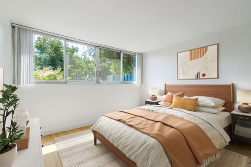 Studio, 1, & 2-BR Apartments in Redwood City, CA - Avenue Two - Bedroom with Hard Surface Flooring, Windows, a Rug, and Stylish Decor at Avenue Two Apartments, Redwood City  , CA 94063