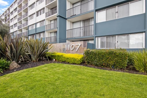 exterior of avenue two apartment building with green lawn at Avenue Two Apartments, California, 94063