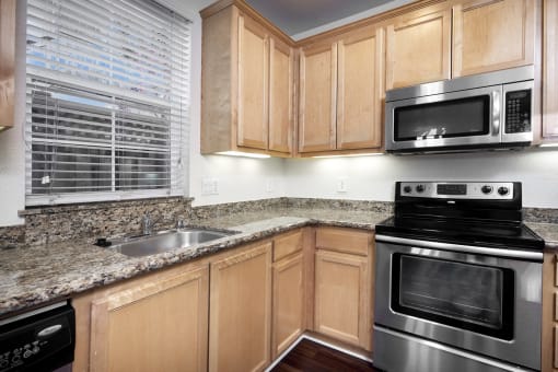 Apartments for Rent San Jose CA - Spacious Kitchen With Hardwood Floor Featuring Convenient Stainless Steel Amenities Such as Fridge, Stove, Microwave, and Dishwasher
