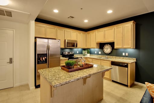 Apartments for Rent in San Jose CA - Aviara - Kitchen with Wood-Style Cabinets, Tile Flooring, and a Kitchen Island