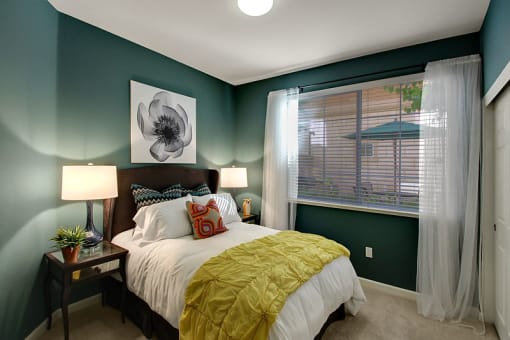 One, Two, and Three-Bedroom Apartments in San Jose, CA - Aviara - Bedroom with Plush Carpeting, a Side Window, Dark Green Walls, and Stylish Decor