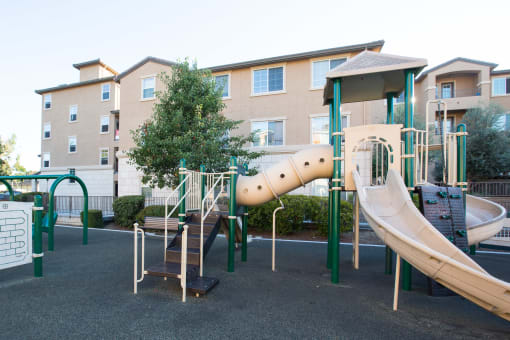 San Jose, CA Apartments for Rent- Aviara- Playground, Padded Area, Building Exterior, and Trees