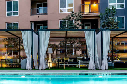 A pool area with a building at Baker Block, Costa Mesa, CA, 92626