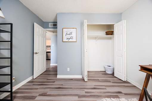 A room with a wooden floor and a white door.
