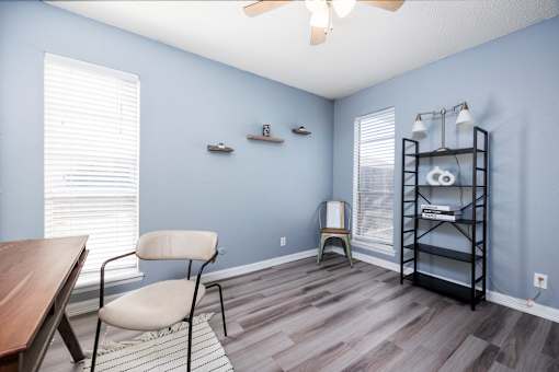 A room with a blue wall and a wooden floor.