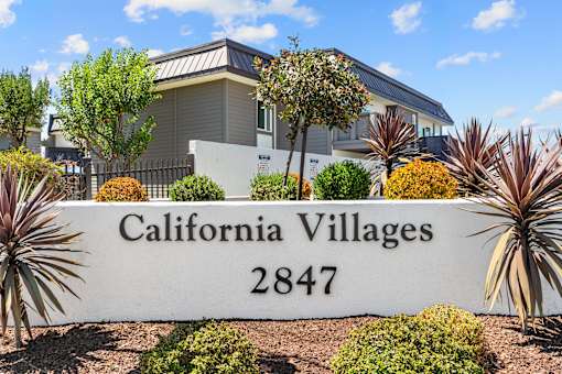 A sign that reads "California Villages 2847" is in front of a house.