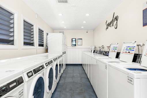 A laundromat with rows of washers and dryers.