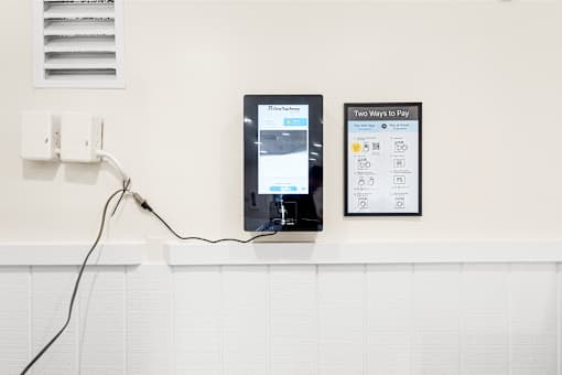 Two tablets are plugged into a wall socket.