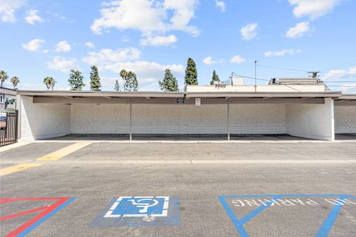 A parking lot with a disabled parking sign painted on the ground.