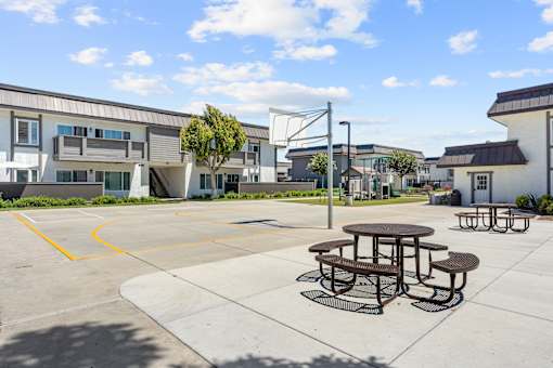A picnic table sits in the middle of a parking lot.