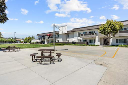 A picnic table sits in the middle of a concrete lot.