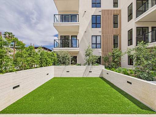 A modern building with a green lawn in front at Skyview Sunset Apartments, Los Angeles, CA, 90046