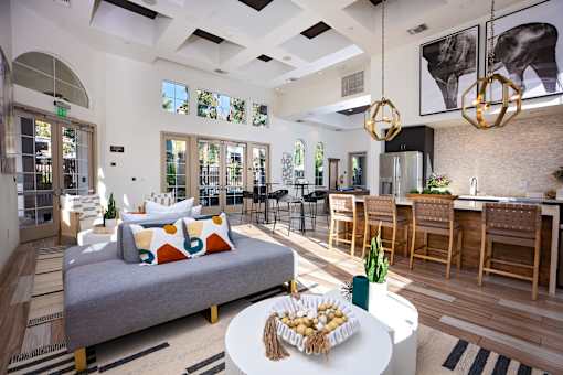 A modern living room with a grey sofa and a white coffee table at Capriana at Chino Hills, California, 91709
