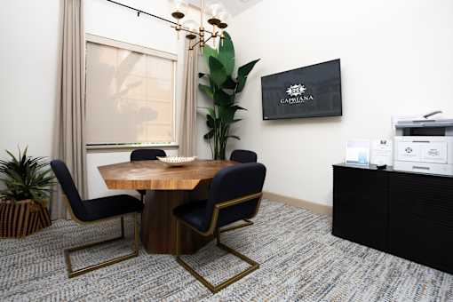 A conference room with a wooden table and chairs at Capriana at Chino Hills, California,