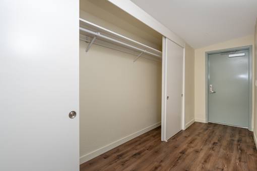 A room with a white door and a grey door.
