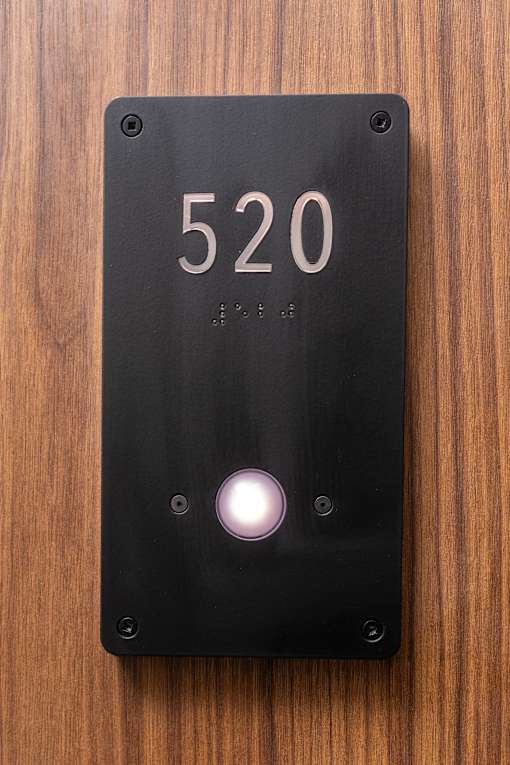 A black door plate with the number 520 on it.