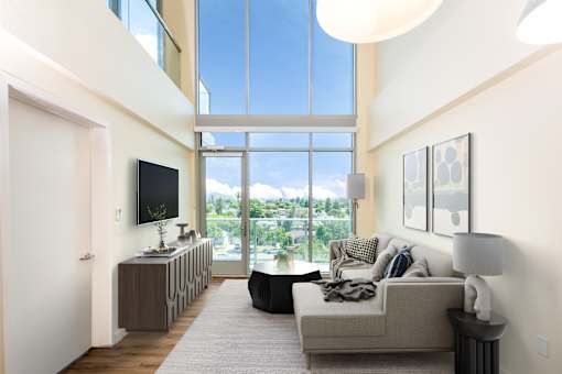 A modern living room with a large window and a flat screen TV.