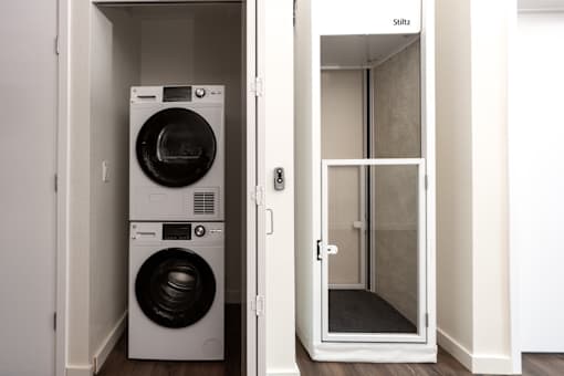 A white washing machine and dryer in a small laundry room.