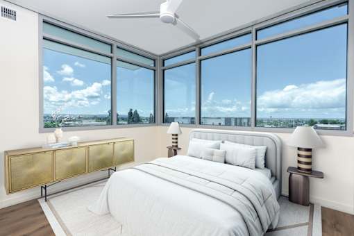 A bedroom with a large bed and a view of the city.