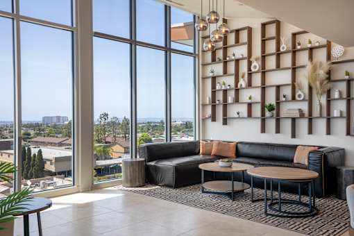 A living room with a large window overlooking a cityscape.