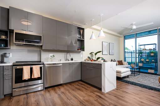 A modern kitchen with a stainless steel oven and a white refrigerator.
