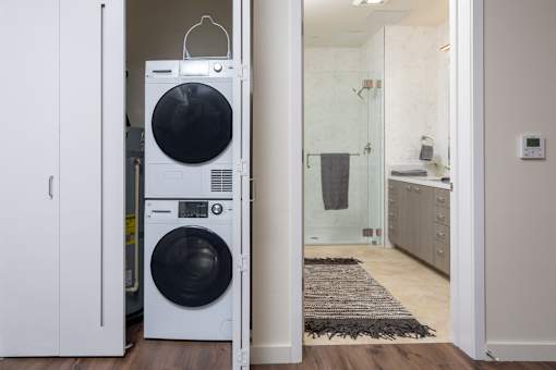 A white washing machine and dryer in a laundry room.