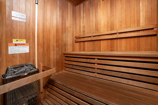 A wooden sauna with a sign on the wall.