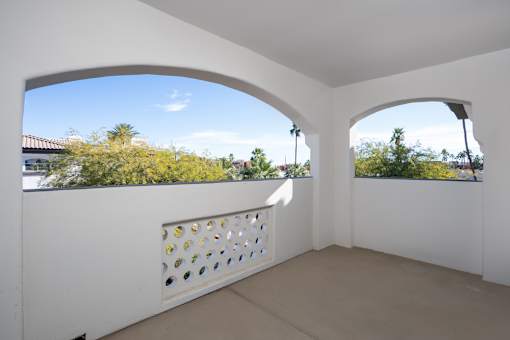 A white room with a window and a view of the outdoors.