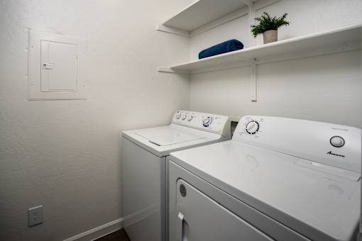 A small laundry room with a washer and dryer.