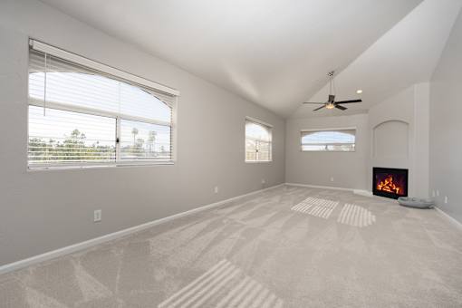 A room with a fireplace and a carpet with a pattern.