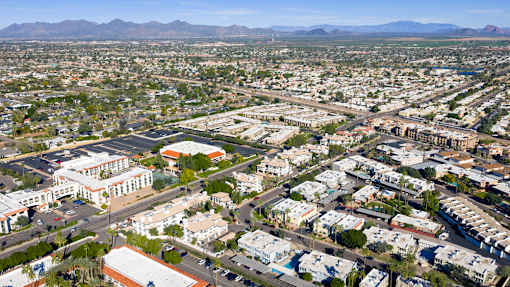 A bird's eye view of a residential area with houses and a large building in the center.