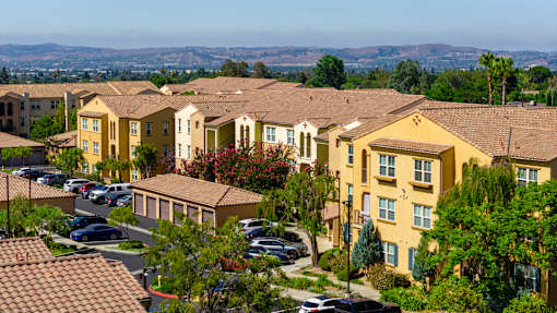A residential area with houses and cars.
