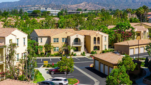A view of a residential area with houses and cars.