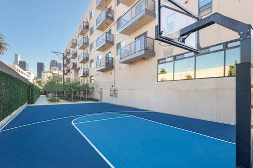 A basketball court is located on the balcony of an apartment building at Wilshire Valencia Apartment, Los Angeles, CA