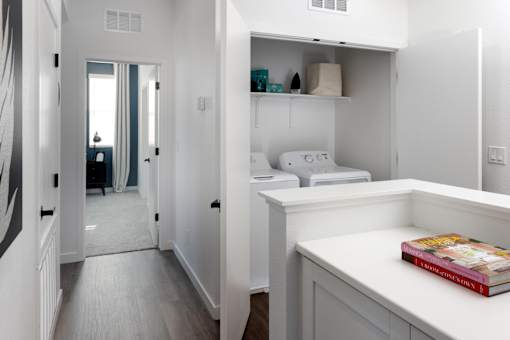 a bedroom with a bed and a desk in a room