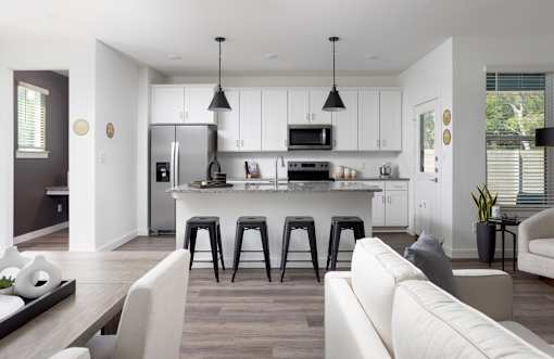 A modern kitchen with white cabinets and a central island.