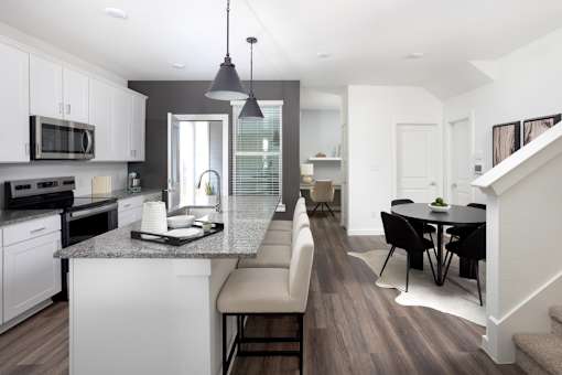 A modern kitchen with a dining area.