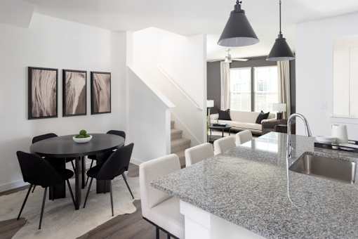 A modern kitchen with a dining table and chairs.