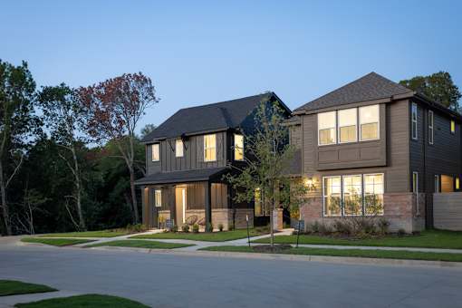 A modern house with a grey exterior and large windows.