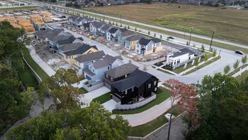 A bird's eye view of a residential area with houses under construction.