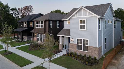 A row of houses with a white and grey exterior.