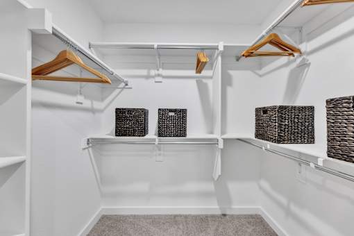 A white closet with two shelves and two baskets.