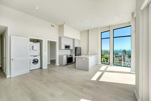 A modern kitchen with a washer and dryer built in at Skyview Sunset Apartments, Los Angeles 90046